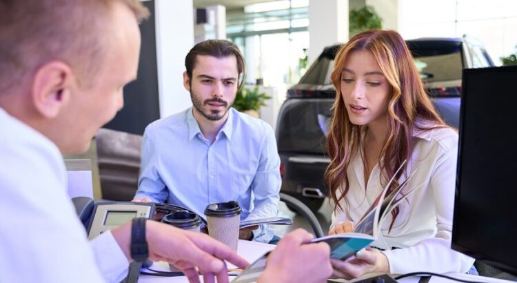 Automotive consultant advising his customers on vehicle purchase