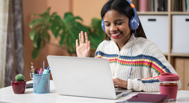 Young African American Girl Doing online video call with teacher from home